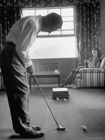 loomis-dean-golfer-ben-hogan-practicing-putting-in-his-town-house-with-wife-valerie-watching-from-armchair.jpg